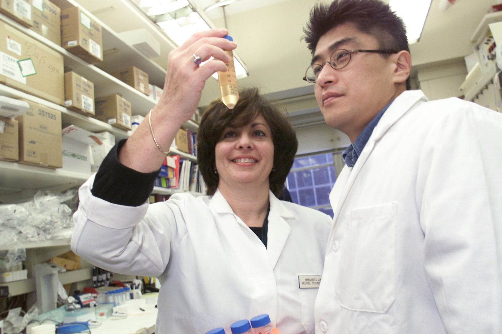 Scientists examine a vial